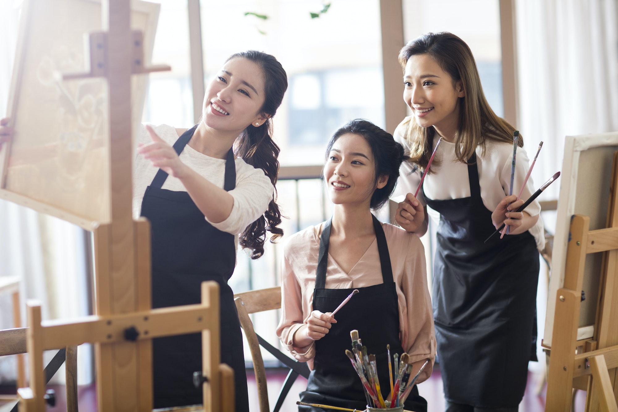 Young women painting in studio